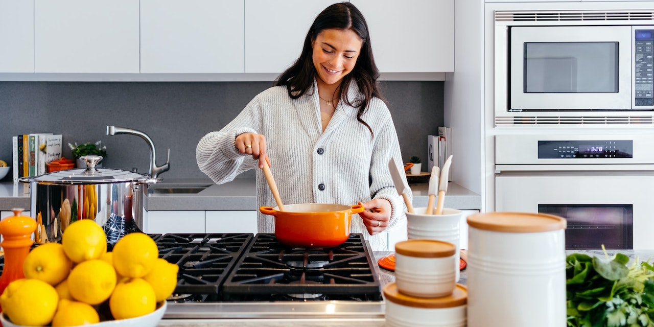 Woman cooking in a grey kitchen