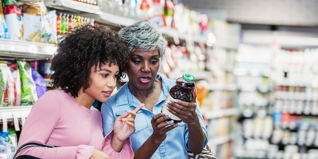 Two women at a supermaket checking the Nutrion facts of a product